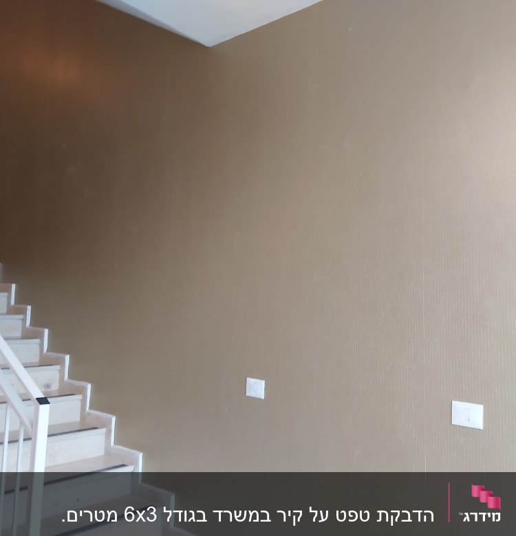 קיר עם טפט חום ליד גרם מדרגות לבן